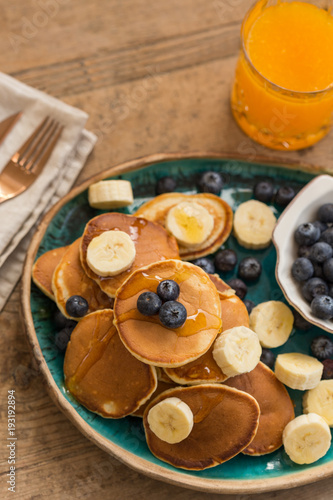 Pancakes with blueberries  banana and fresh orange juice