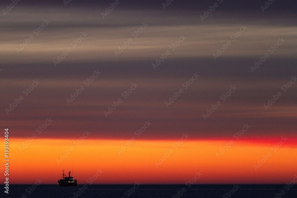 Fototapeta premium Fishing-boat during sunset