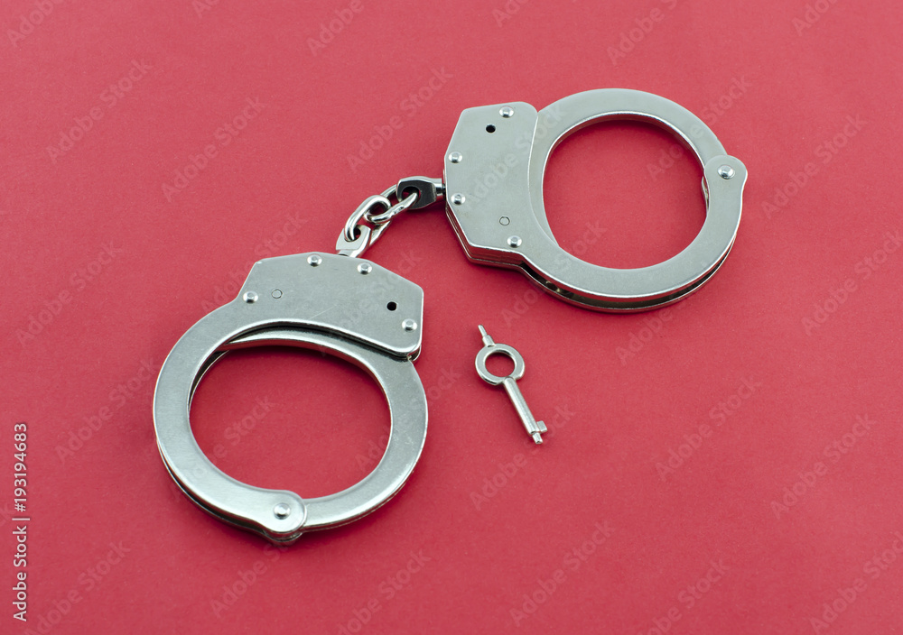 Handcuffs and key isolated Handcuffs and key isolated