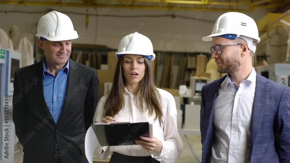 Young female executive manager providing excursion for inspection, or sponsors on furniture manufacture slow motion Young female executive manager providing excursion for inspection, or sponsors on furniture manufacture slow motion