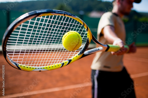 Tennis player in action on a tennis court © lightpoet