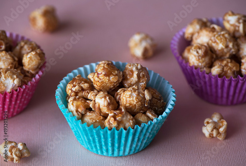 Sweet caramel popcorn in colorful cups