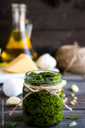 Fresh homemade pesto sauce and ingredients to it