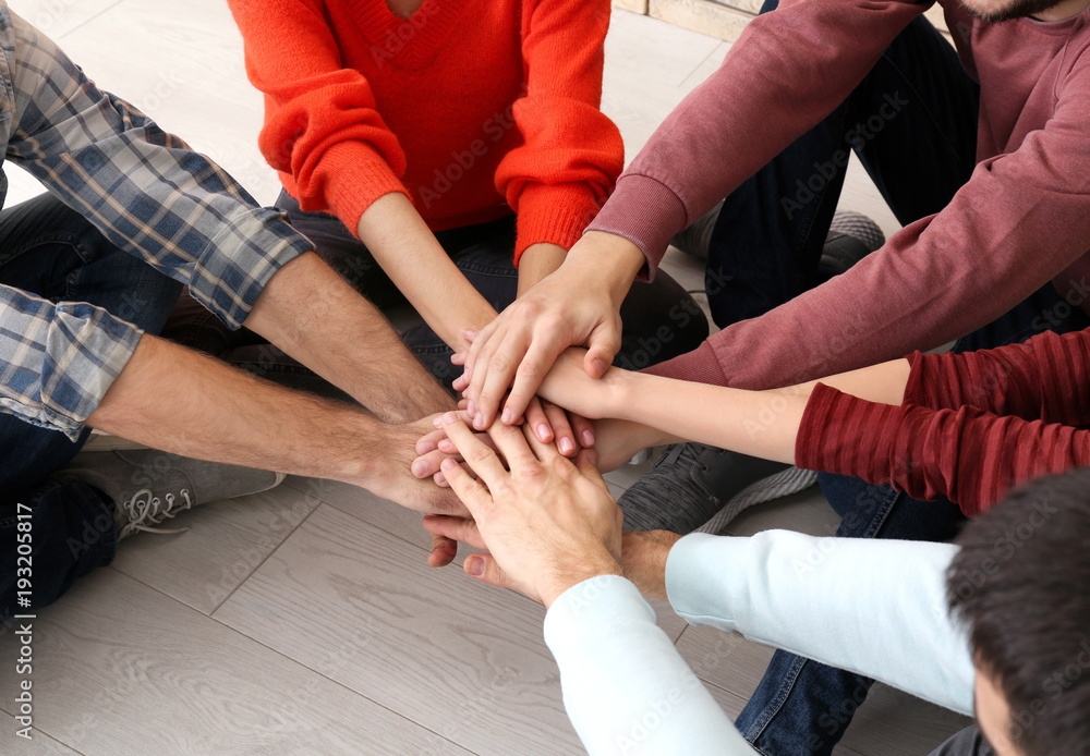 People putting hands together, closeup. Unity concept People putting hands together, closeup. Unity concept