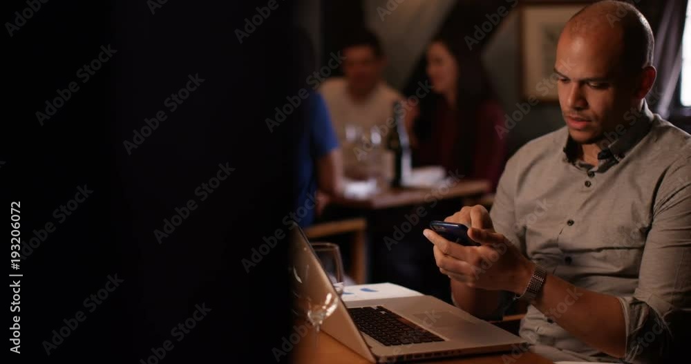 4K Concerned businessman working on laptop in restaurant makes phone call to a colleague to discuss a problem 4K Concerned businessman working on laptop in restaurant makes phone call to a colleague to discuss a problem