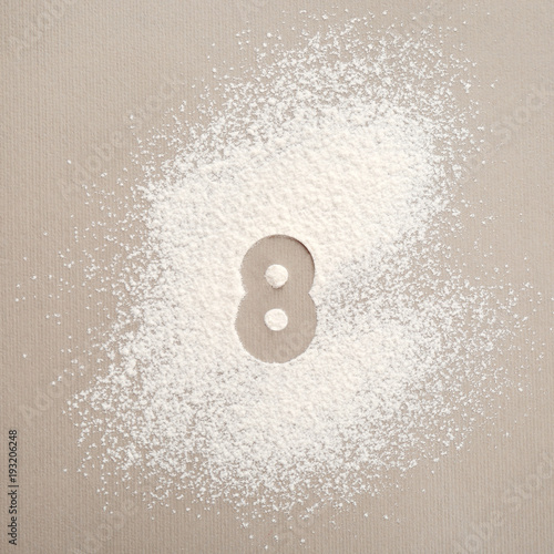 Tableau sur toile Silhouette of figure 8 on scattered flour