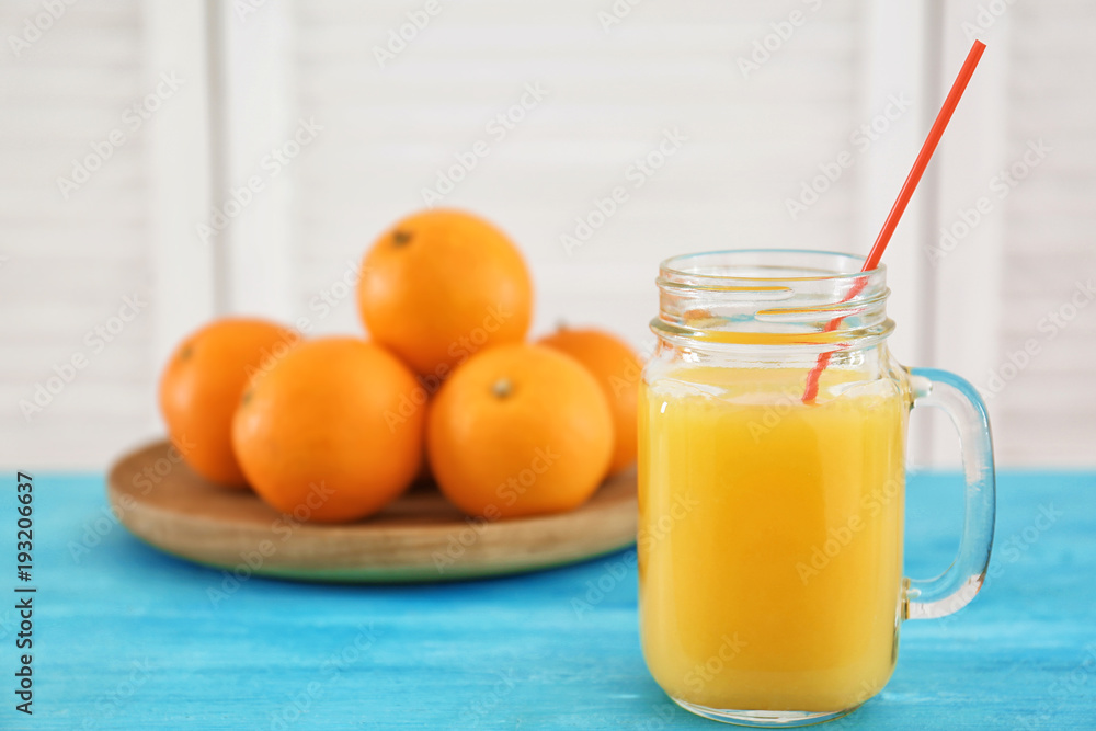 Mason jar with fresh orange juice on table Mason jar with fresh orange juice on table
