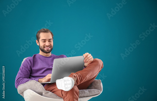 Handsome man with laptop si...