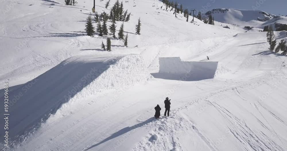 Skier does aerial stunt off quarter pipe Skier does aerial stunt off quarter pipe