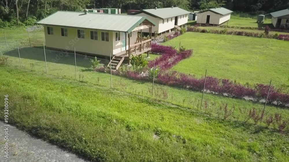 A birds eye view shot of house and trees. Camera moves forward A birds eye view shot of house and trees. Camera moves forward