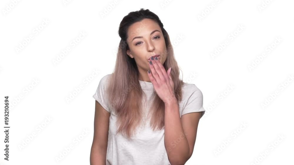 Portrait of flirty woman with dyed hair blowing air kiss on camera, over white background in slow motion. Concept of emotions Portrait of flirty woman with dyed hair blowing air kiss on camera, over white background in slow motion. Concept of emotions