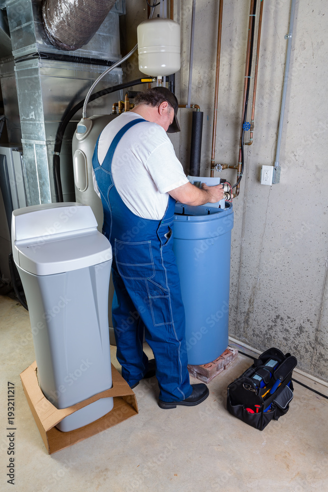 Installer inputting settings on a water softener