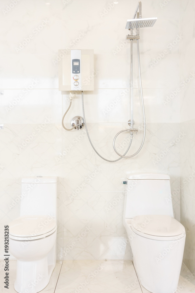 Bathroom interior with shower, water heater and toilet on white tiles wall  Stock Photo | Adobe Stock
