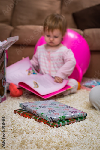 A girl reading a book Christmas morning 