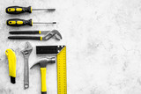 Various repair tools. Must-have for men. Equipment for building. Repair tool kit. Grey background top view pattern copy space