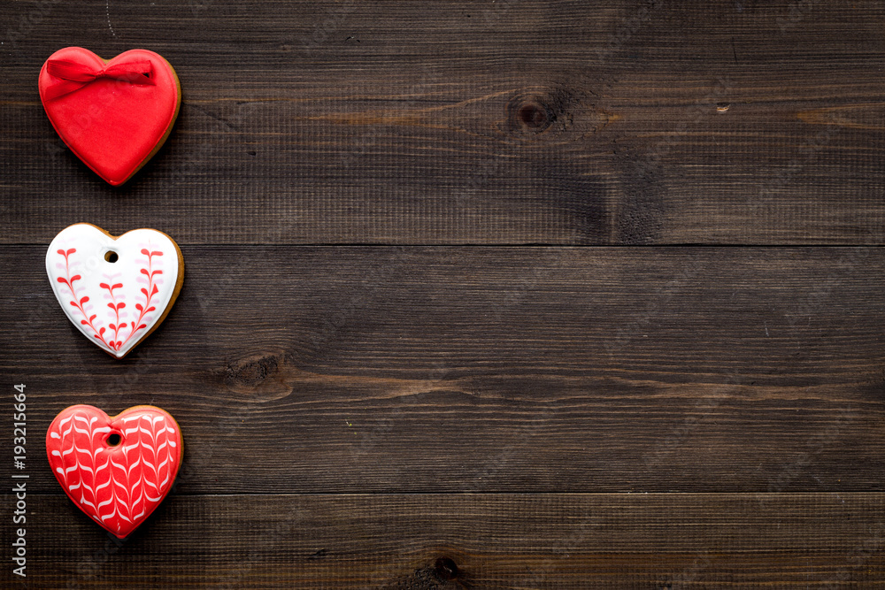 Fototapeta premium St Valentine's Day cookies in shape of heart on dark wooden background top view copy space