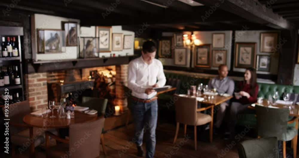 4K Portrait of smiling restaurant owner, taking customer orders with a tablet computer 4K Portrait of smiling restaurant owner, taking customer orders with a tablet computer