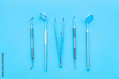 Dentist tools. Prevention of diseases of the oral cavity. Dentist appointment. Blue background top view