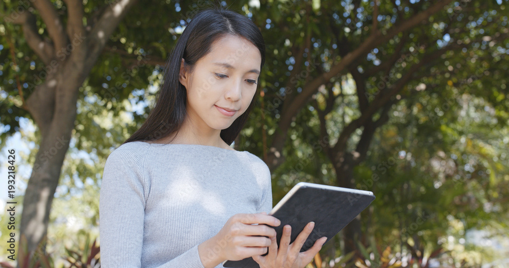 Fototapeta premium Woman use of tablet computer at outdoor