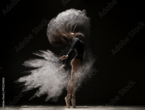 Woman in undrewear and pointe shoes in dust cloud