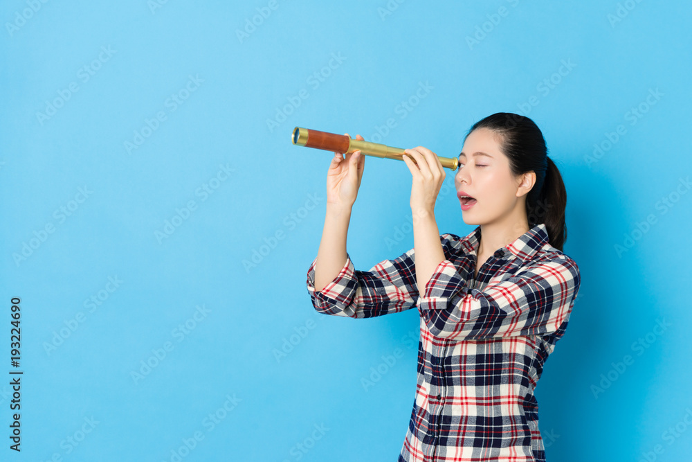 young female teenager standing in blue background young female teenager standing in blue background