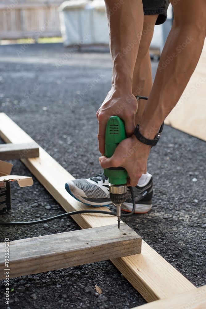 man worker working with an electric drill man worker working with an electric drill