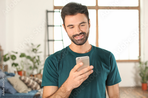 Young man using mobile phon...