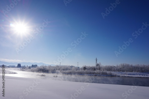 川と雪景色　太陽　青空　冬 © amosfal