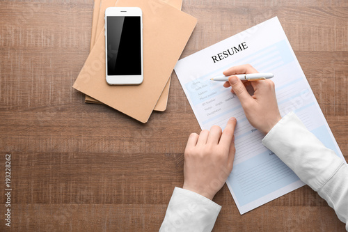 Woman filling in resume for...