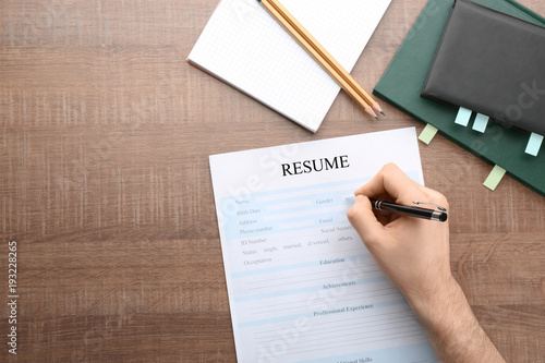 Woman filling in resume for...