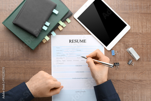 Woman filling in resume for...