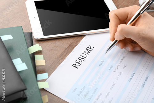 Woman filling in resume for...