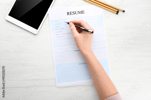 Woman filling in resume for...