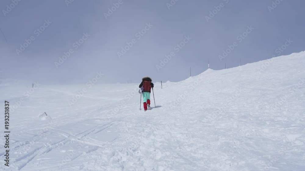 Girl hiking on snow in Slovak mountains during sunny day in winter Girl hiking on snow in Slovak mountains during sunny day in winter