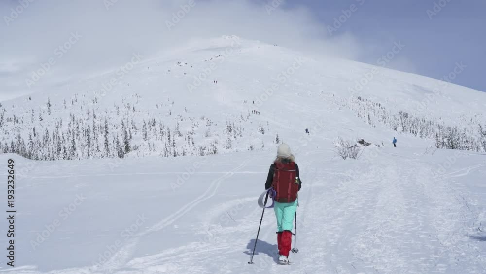 Girl hiking on snow in Slovak mountains during sunny day in winter Girl hiking on snow in Slovak mountains during sunny day in winter
