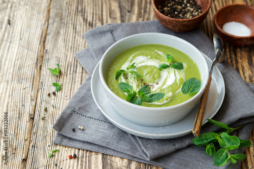 Green peas and broccoli soup . Wooden background  Scandinavian style  