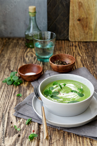 Green peas and broccoli soup . Wooden background, Scandinavian style
