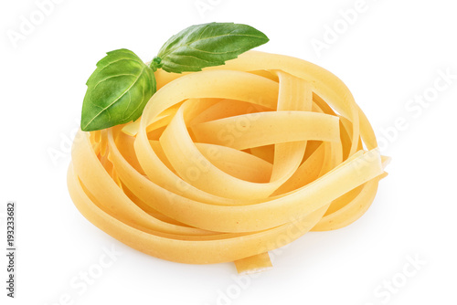 Raw tagliatelle pasta and basil isolated on white background.