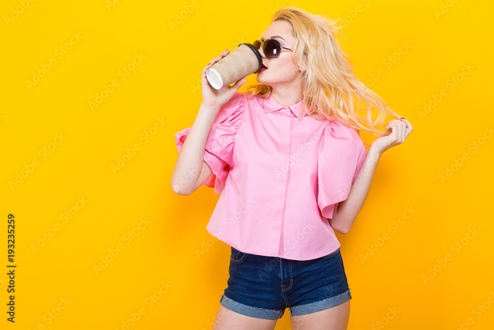Woman in pink blouse with sunglasses drink coffee Woman in pink blouse with sunglasses drink coffee