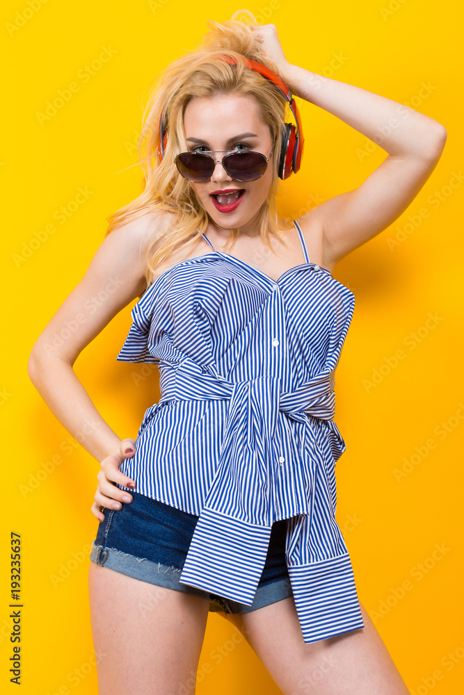 Fototapeta premium Girl in blouse with headphones and sunglasses