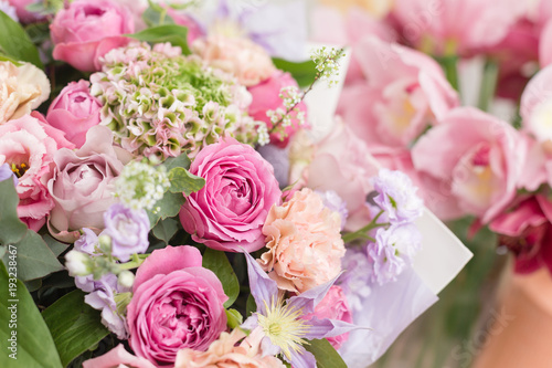 Fototapeta Naklejka Na Ścianę i Meble -  Close-up beautiful luxury bouquet of mixed flowers in glass vases. the work of the florist at a flower shop. Wallpaper