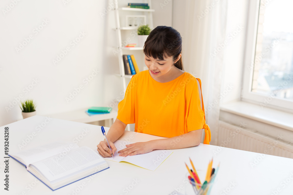 happy student girl with book and notebook at home happy student girl with book and notebook at home