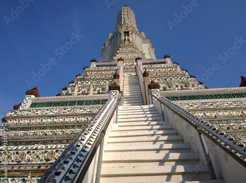 Details of famous Wat Arun buddhist temple  Bangkok  Thailand  East Asia  with its rich decoration  stairs  elephants and giants. daylight  outdoor  tourism industry  religion  buddhism