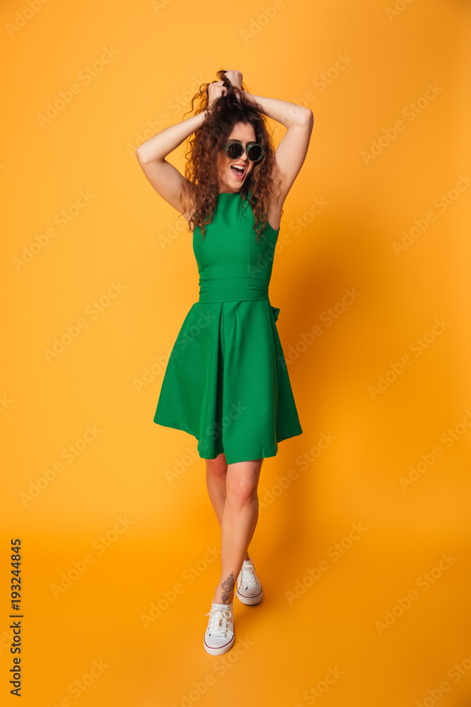 Excited young woman wearing sunglasses. Excited young woman wearing sunglasses.