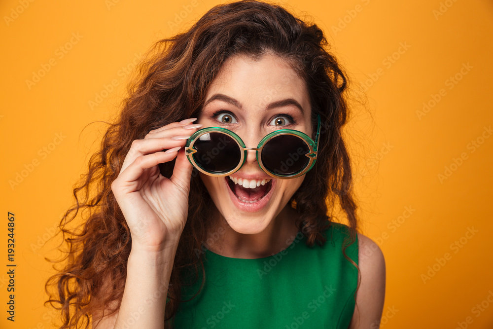 Excited young woman wearing sunglasses. Excited young woman wearing sunglasses.