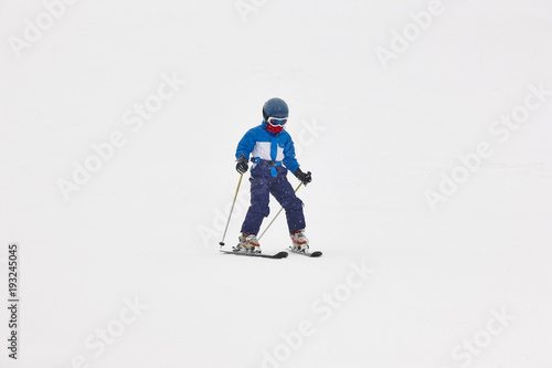 Chidren skiing under the snow. Winter sport. Ski slope
