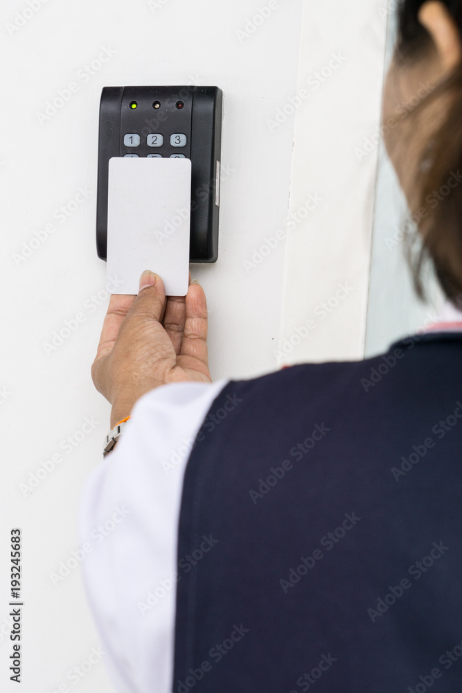 Security alarm keypad with female hand and card, closeup Security alarm keypad with female hand and card, closeup