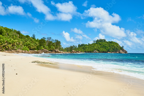 beautiful paradise beach anse bazarca. white sand turquoise water palm trees  granite rocks  seychelles