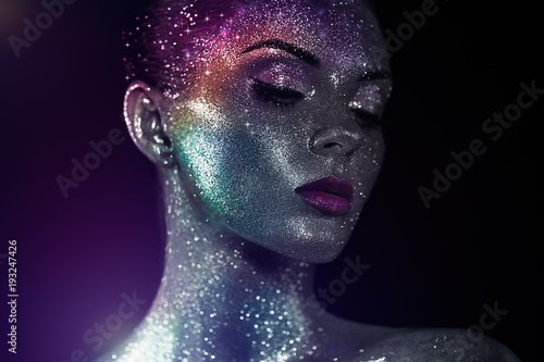 Portrait of Beautiful Woman with Sparkles on her Face. Girl with Art Make-Up in Color Light. Fashion Model with Colorful Makeup © Oleg Gekman