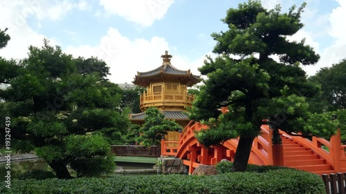 a gimbal shot walking towards the bridge and pavilion of absolute perfection in nan lian gardens in hong kong, china